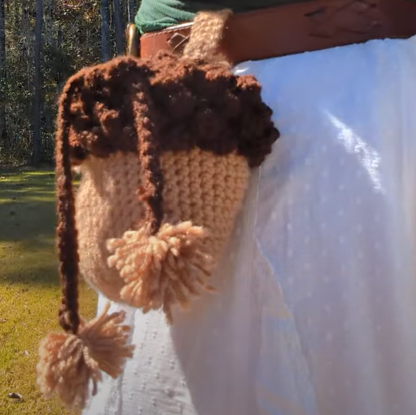 Acorn shaped drawstring bag with pom pom tassels