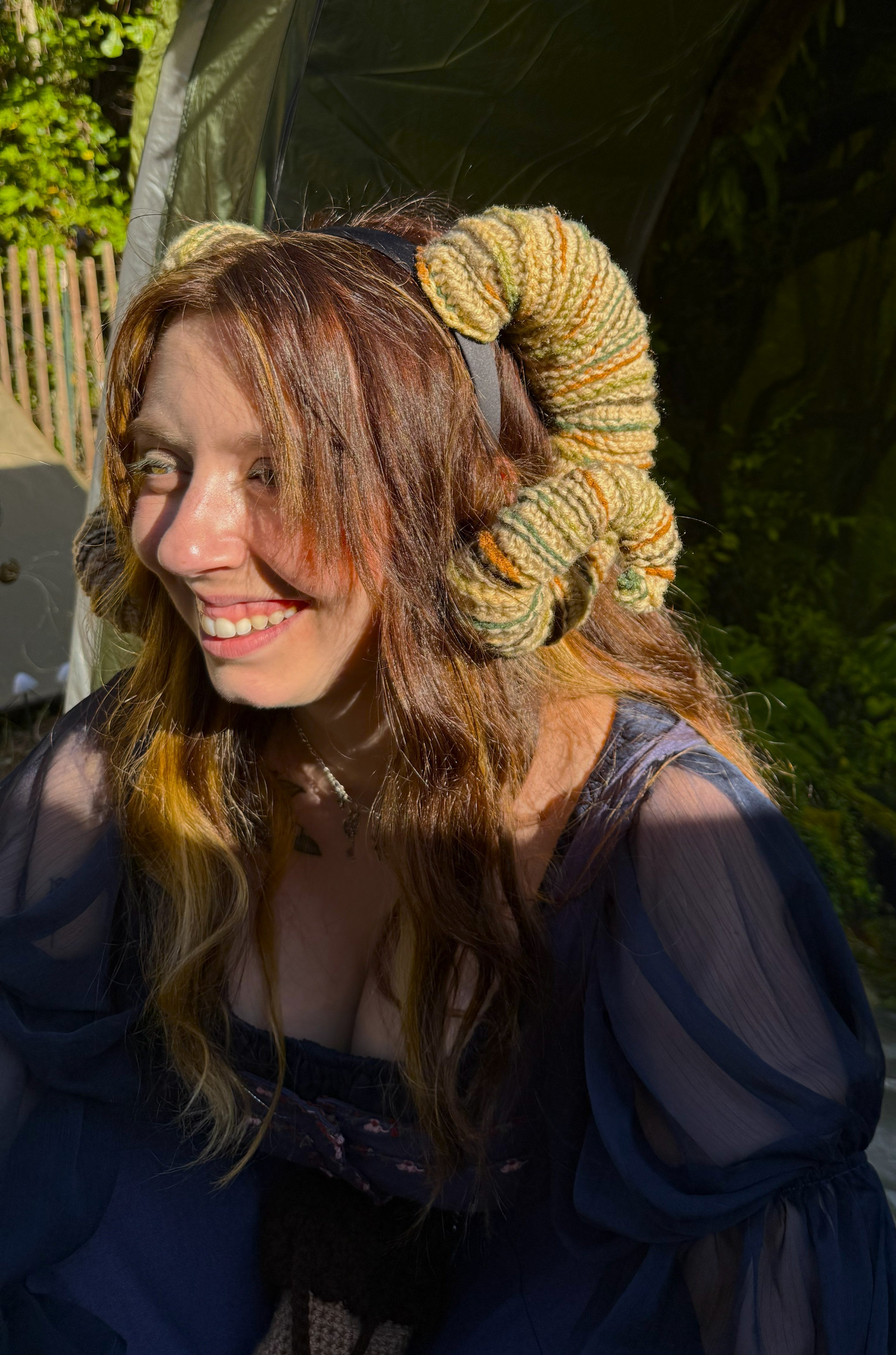Woman wearing a large knitted headband outdoors